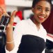 Woman buying the car. Lady in a car salon. Elegant black girl